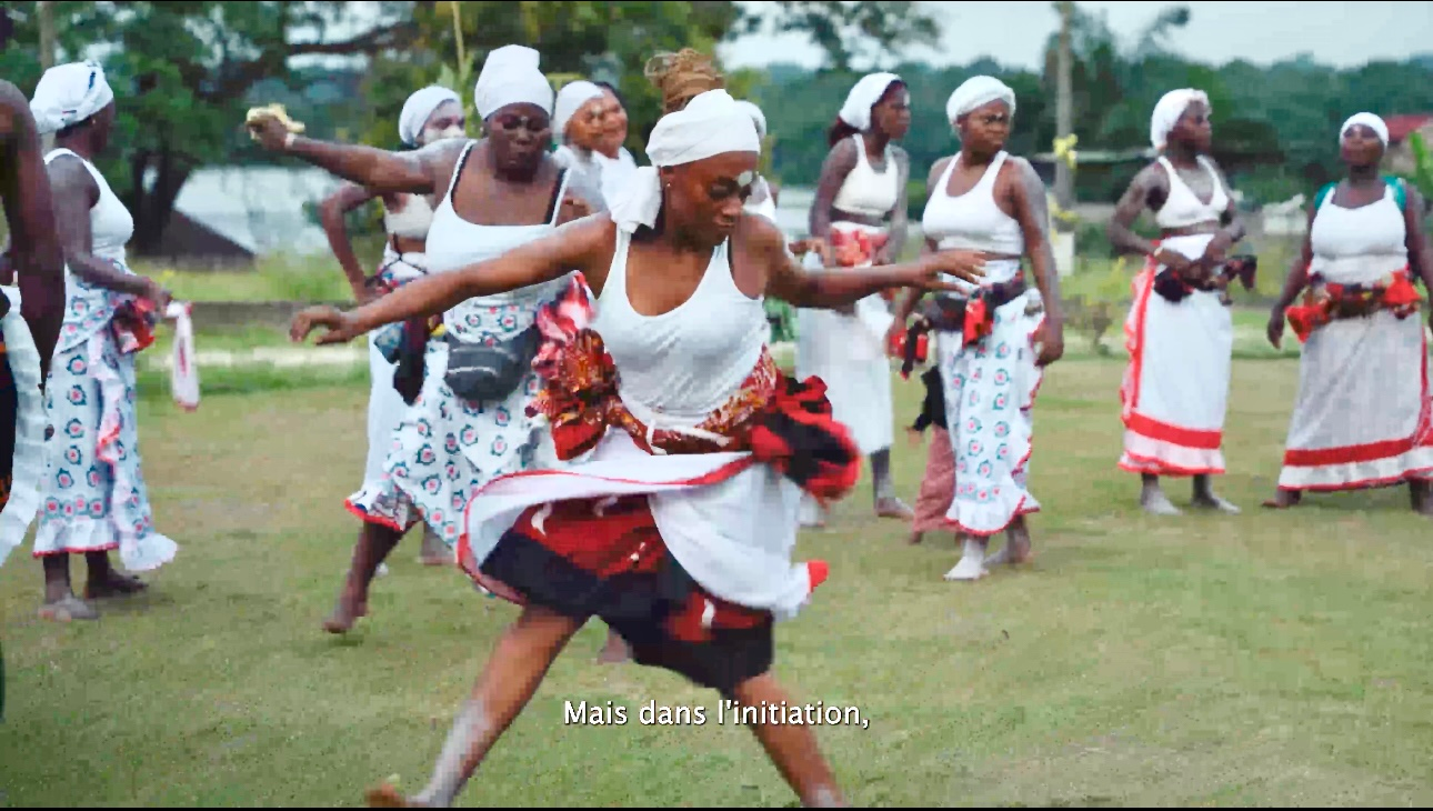 Danseurs en tenues rouges et blanches sur une pelouse