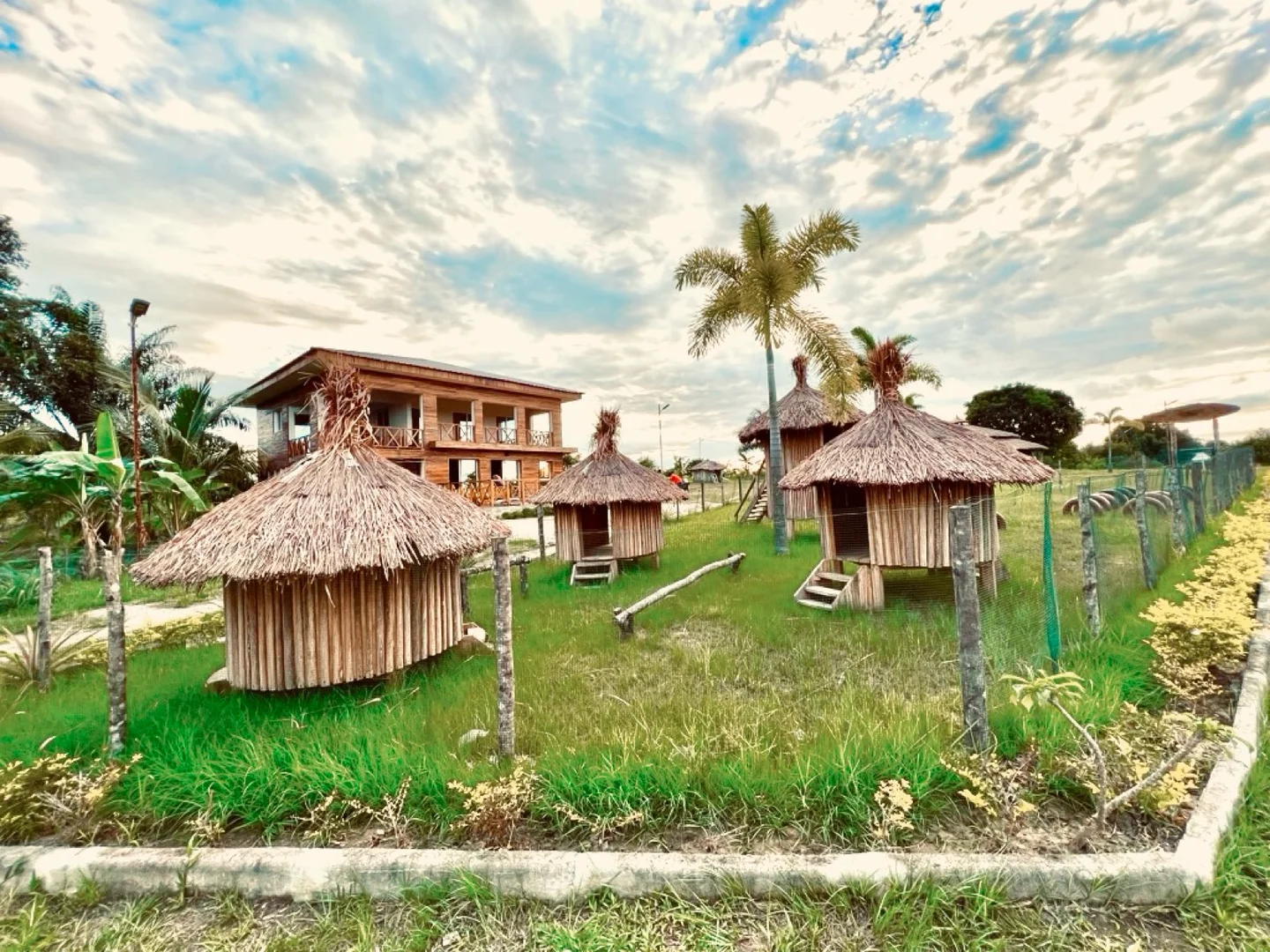 Paillotes et pelouses de Ndossi Village près de la rivière